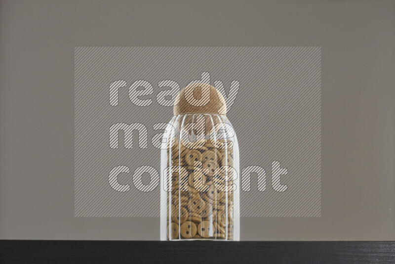 Buttons in a glass jar on black background