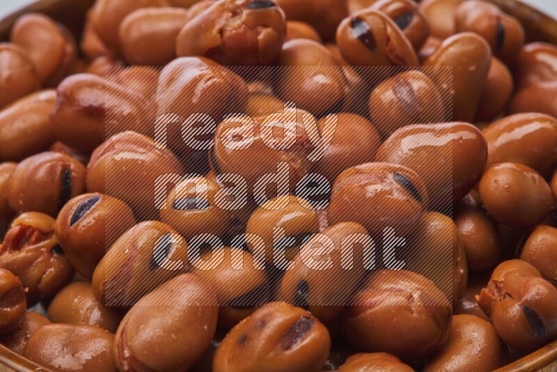Close up shot of cooked fava beans (foul) on white background