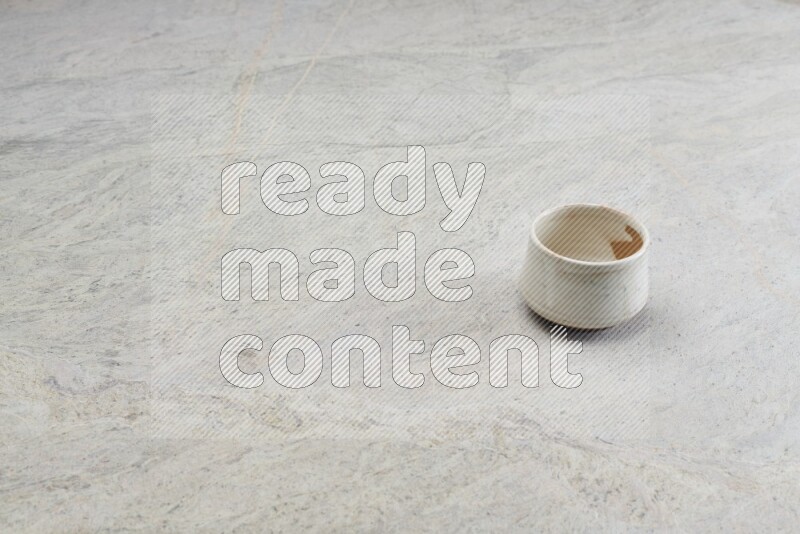 A white pottery bowl on grey marble background