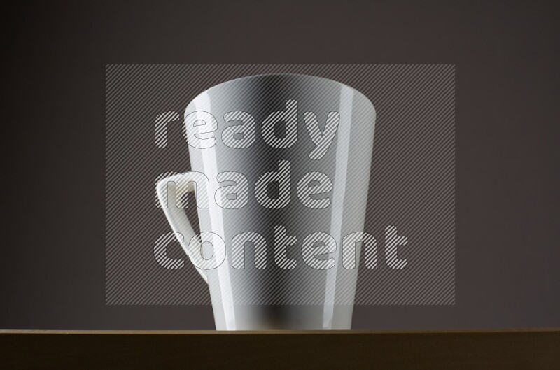 Low angle shot of a white cup on grey background