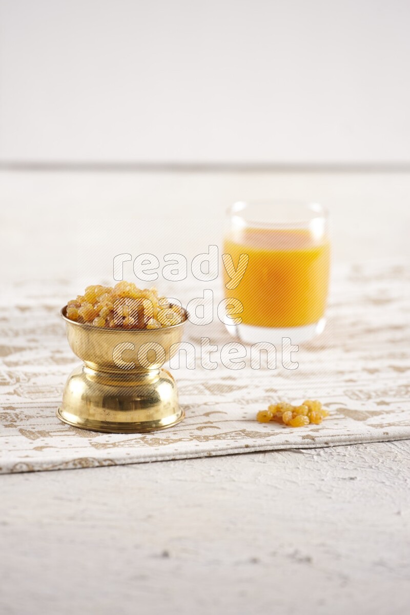 Dried fruits in a metal bowl with qamar eldin in a light setup