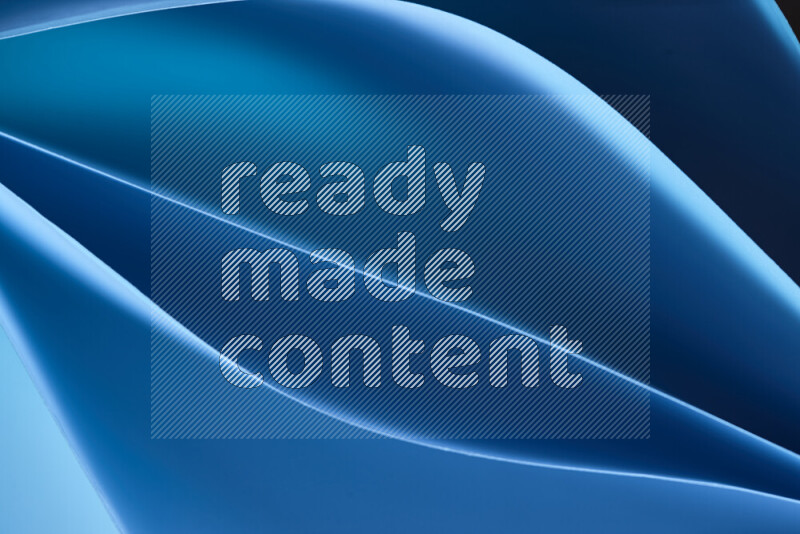 هذه الصورة تعرض تكوين فن الورق التجريدي مع منحنيات ورقية بتدرجات اللون الأزرق المكونه بواسطة الضوء الملون