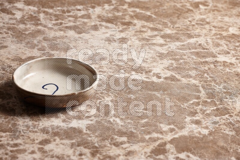 Multicolored Pottery Bowl on Beige Marble Flooring