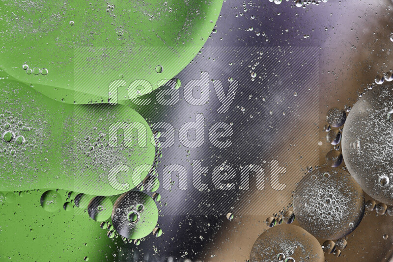 Close-ups of abstract oil bubbles on water surface in shades of black, green and brown