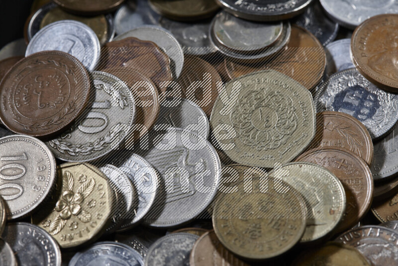 A close-ups of random old coins on black background