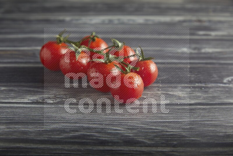 Red cherry tomato vein on a textured grey wooden background 45 degree