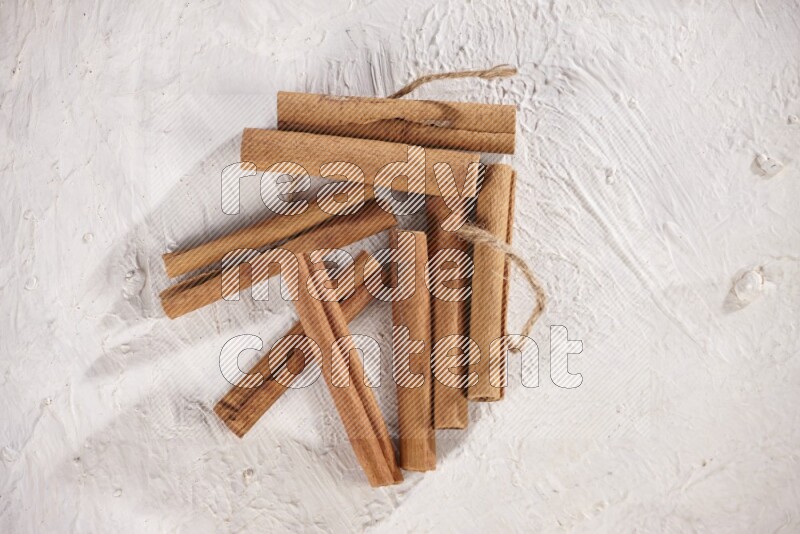 An unbounded stack of cinnamon sticks on white background