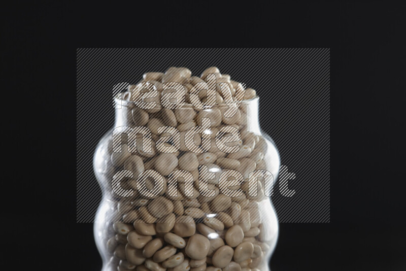 Lupin Beans in a glass jar on black background