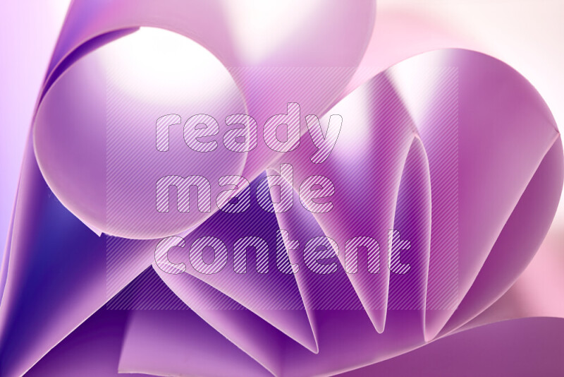 An artistic display of paper folds creating a harmonious blend of geometric shapes, highlighted by soft lighting in purple tones