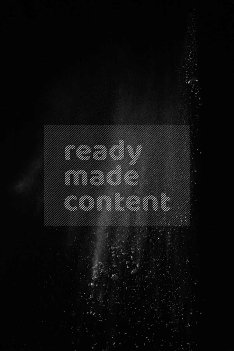 A side view of white powder explosion on black background