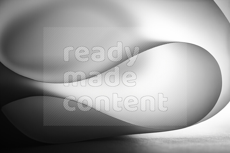 فن تجريدي يعرض منحنيات وتدرجات اللون الرمادي مكونه بضوء ملون