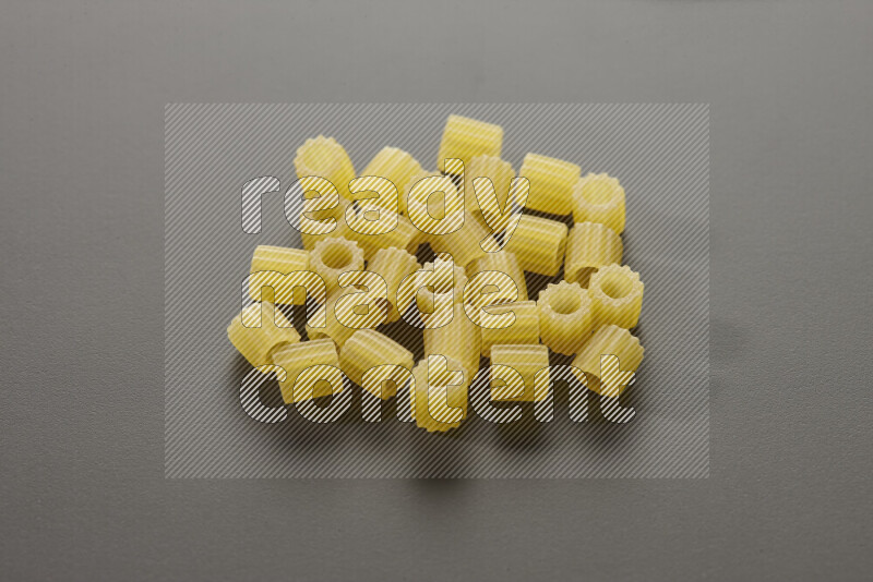 Small rings pasta on grey background