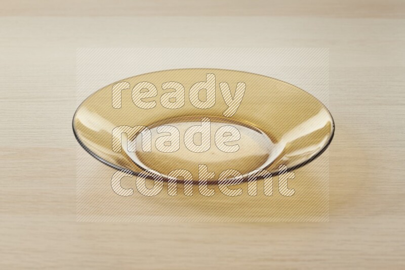 A circular glass plate on light wooden background