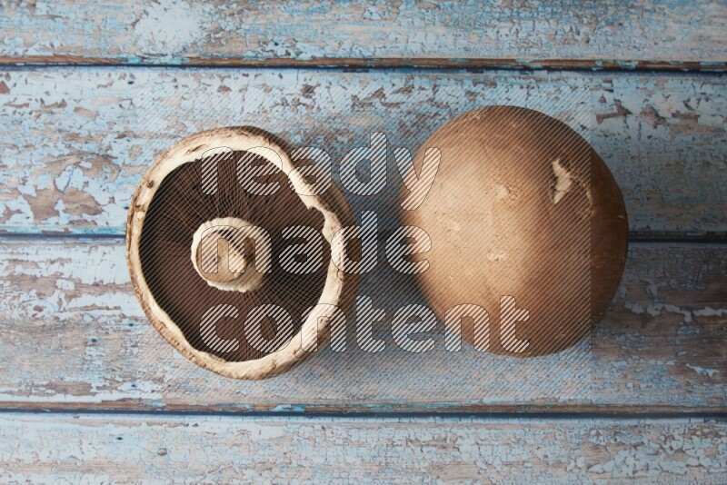 Fresh portobello mushrooms topview on a light blue wooden background