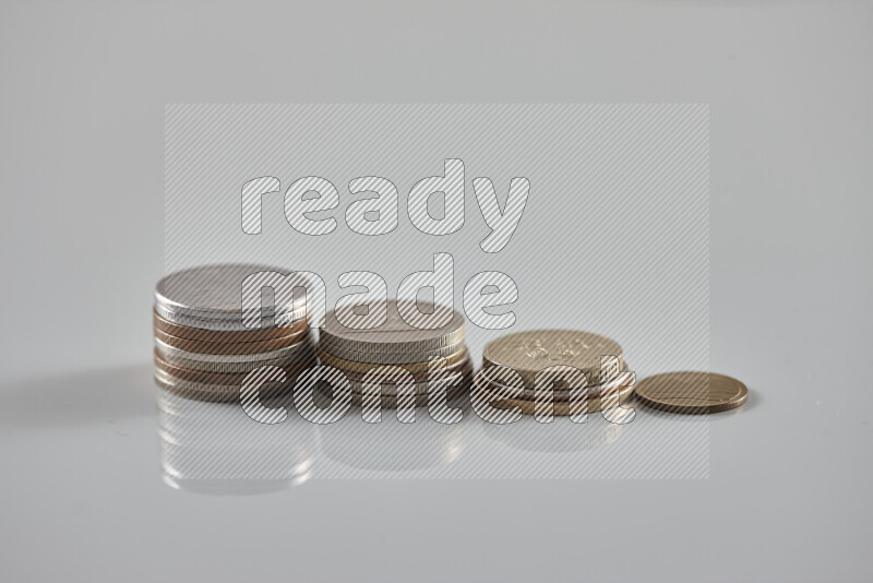 Random old coins on grey background