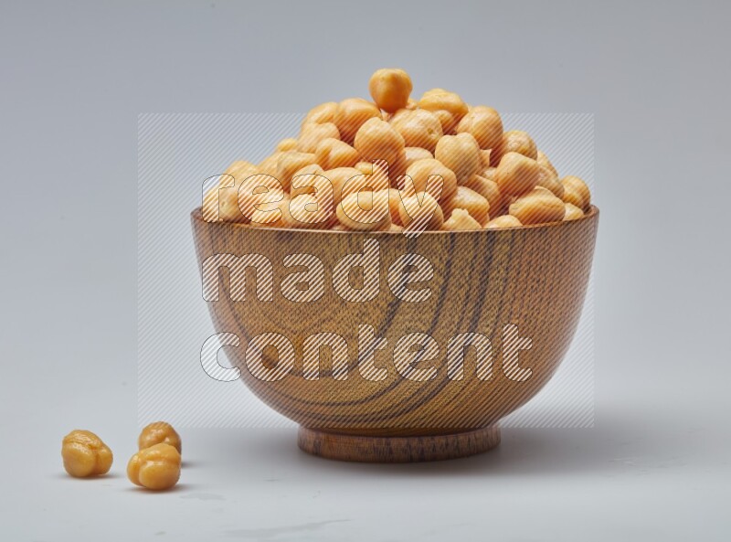 Close up of a boiled chickpeas in a container on white background