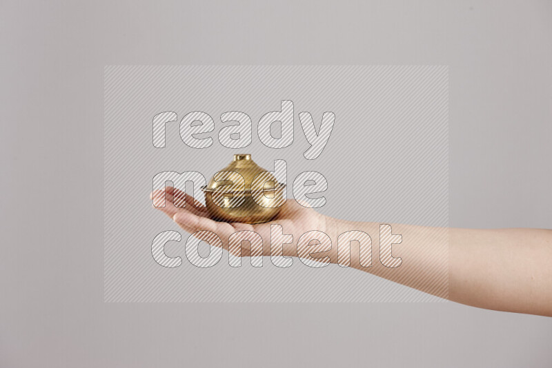 Woman hands holding different metal essentials in different positions
