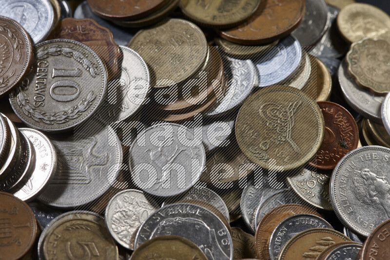 A close-ups of random old coins on black background