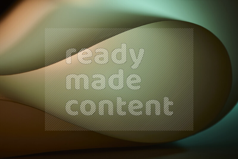 An abstract art piece displaying smooth curves in green and orange gradients created by colored light