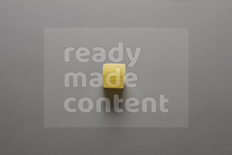 Big rings pasta on grey background