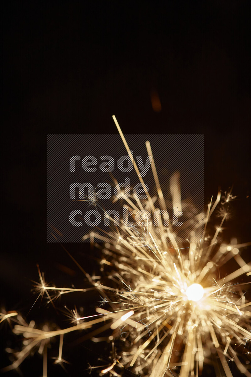A close-up image of sparkler candle isolated on black background