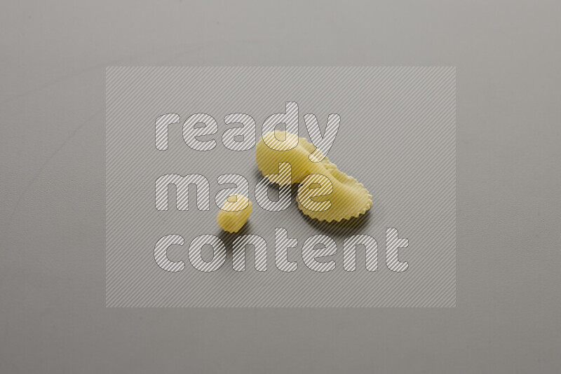 Small rings pasta with other types of pasta on grey background