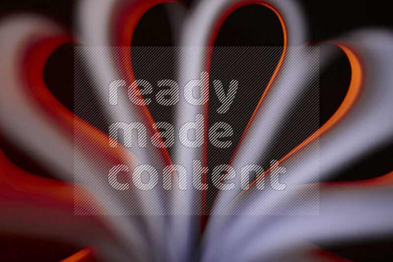 An abstract art piece displaying smooth curves in white and orange gradients created by colored light