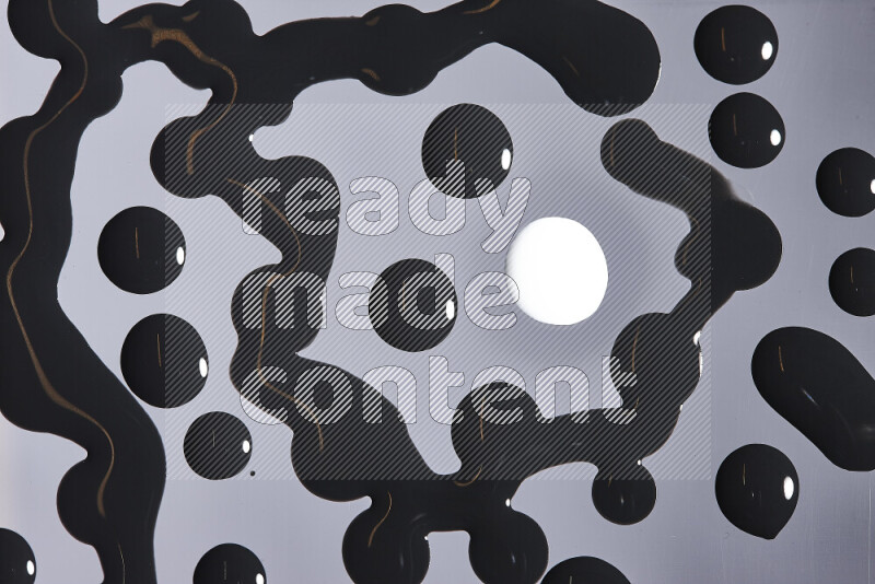 Close-ups of abstract white and black paint droplets on the surface