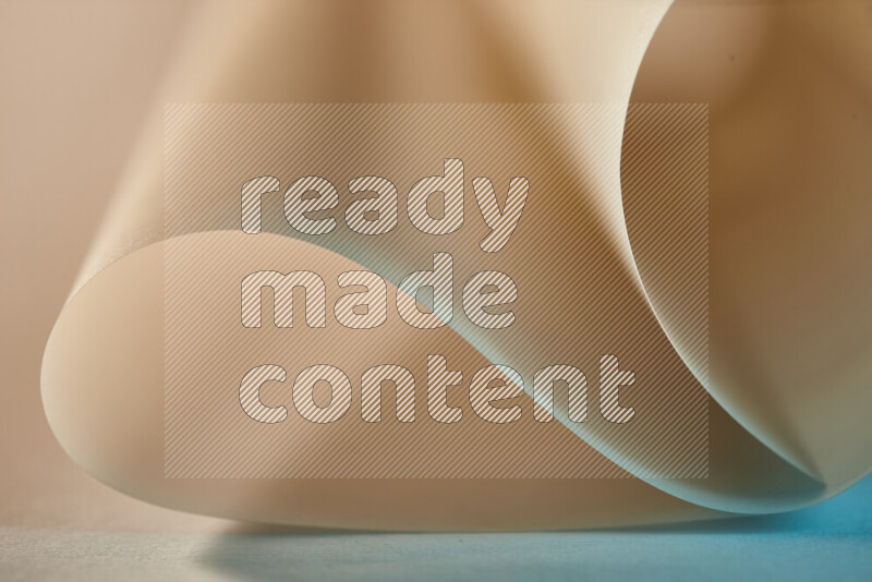 An abstract art piece displaying smooth curves in blue and gold gradients created by colored light