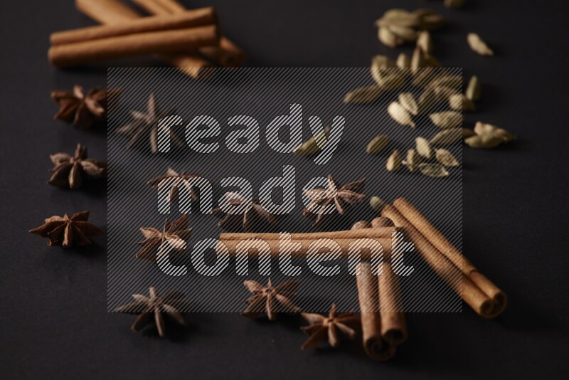 Cinnamon Sticks, Cardamom and star anise on a black background