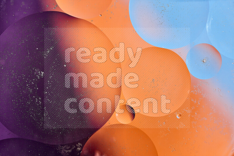 Close-ups of abstract oil bubbles on water surface in shades of blue, orange and purple