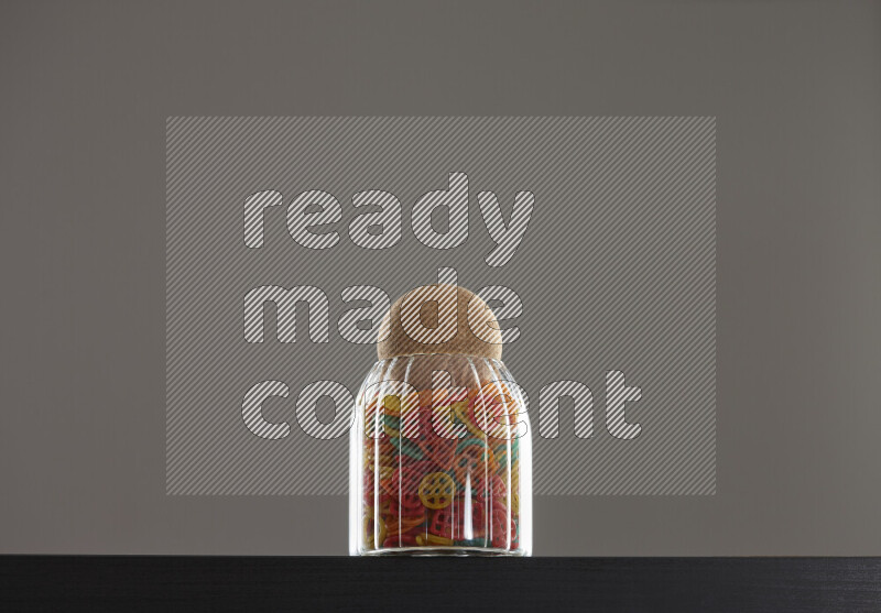 Snacks in a glass jar on black background