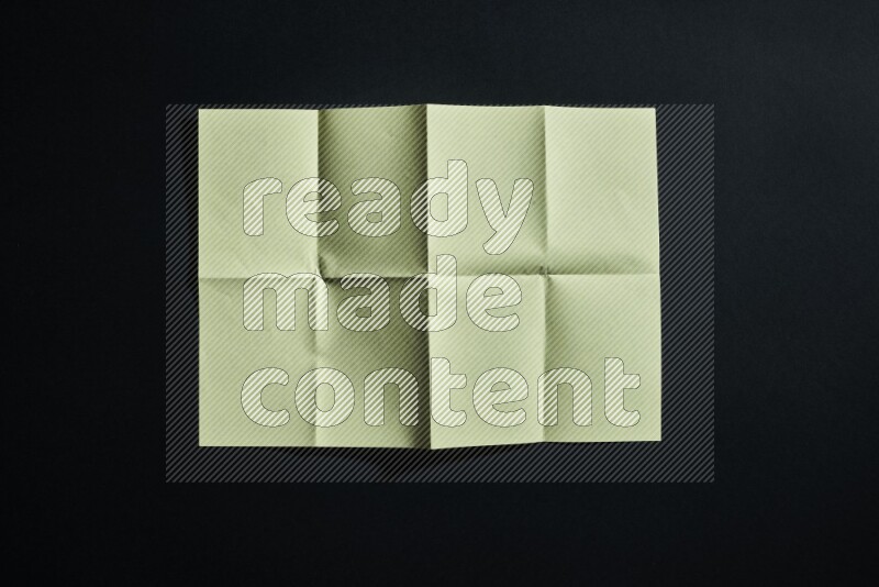 Yellow paper sheet on black background