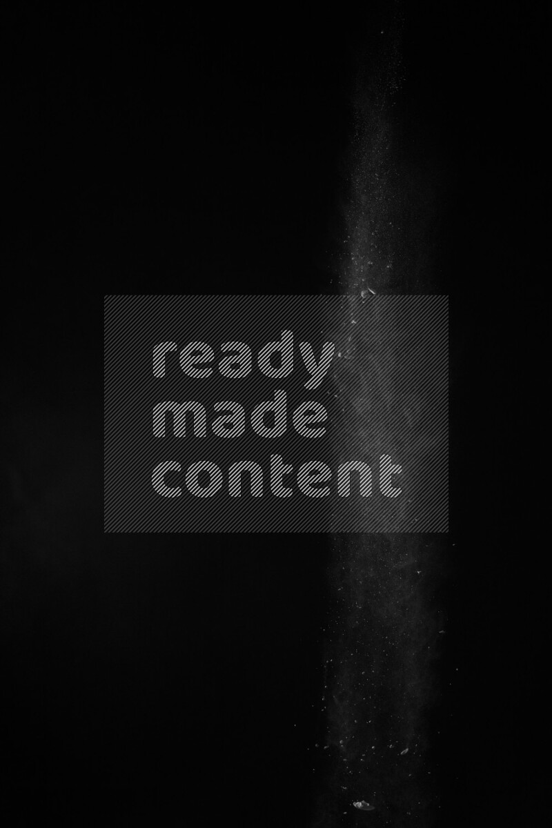 A side view of white powder explosion on black background