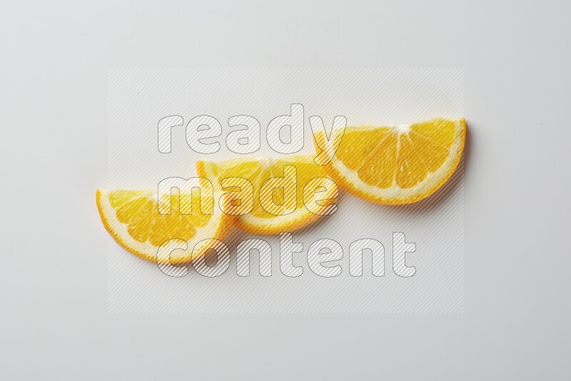Three halves of an orange slices on white background