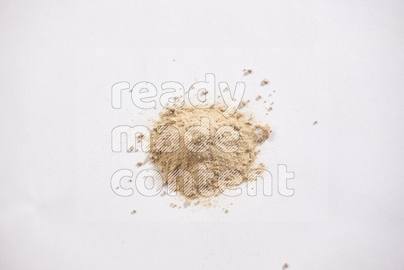A small pile of garlic powder on a white background