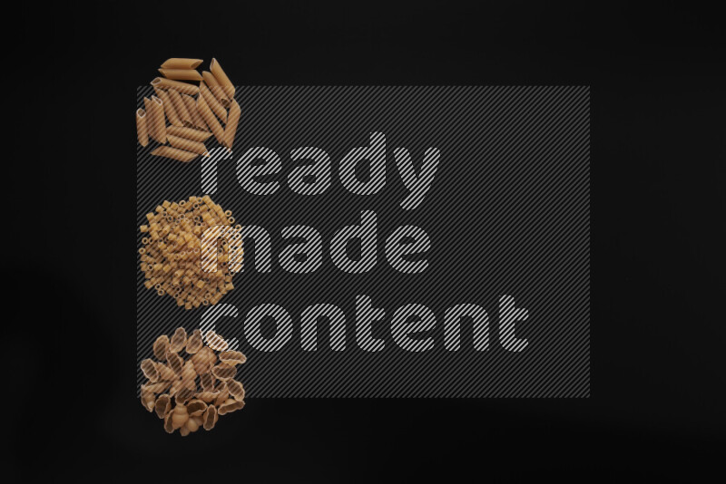 Different pasta types in 3 bunches on black background