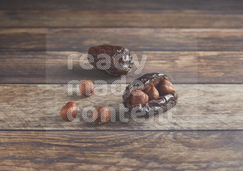 two hazelnut stuffed madjoul date on a wooden background