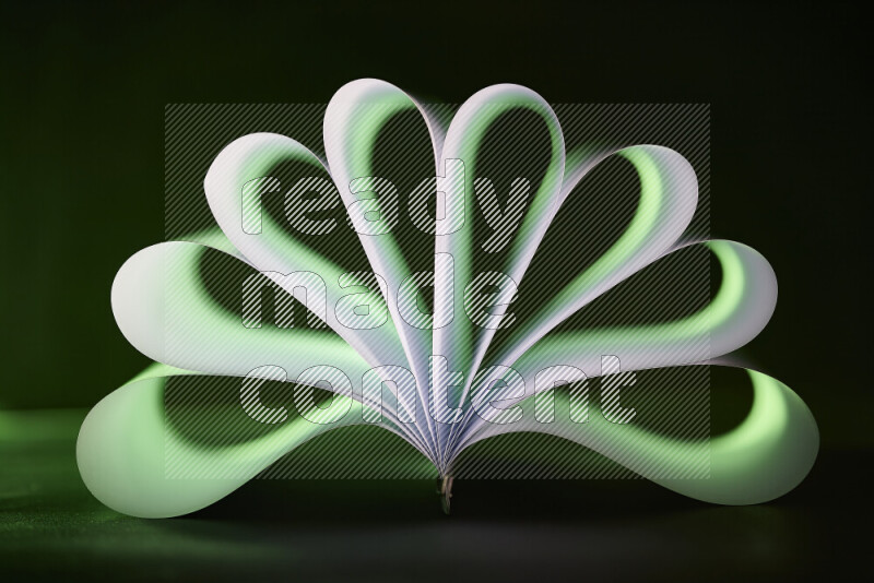 An abstract art piece displaying smooth curves in green and white gradients created by colored light