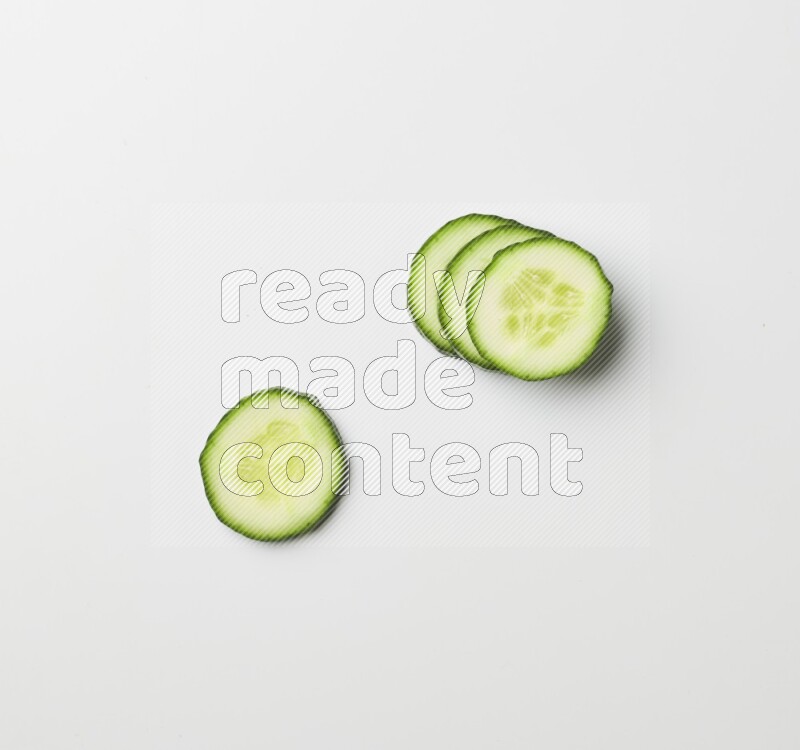 Multiple cucumber slices on white background