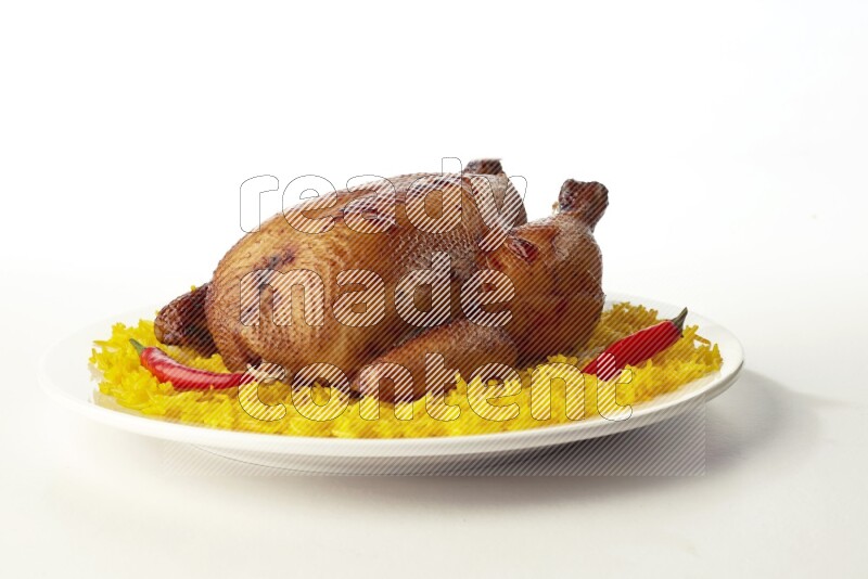 yellow  basmati Rice with  whole roasted chicken on a white rounded plate direct on white background