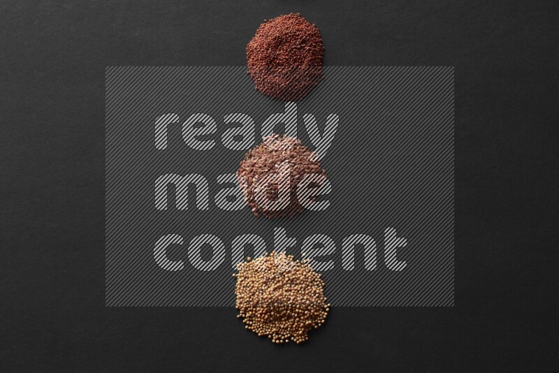 Black seeds, mustard seeds, garden cress and flax on a Black background