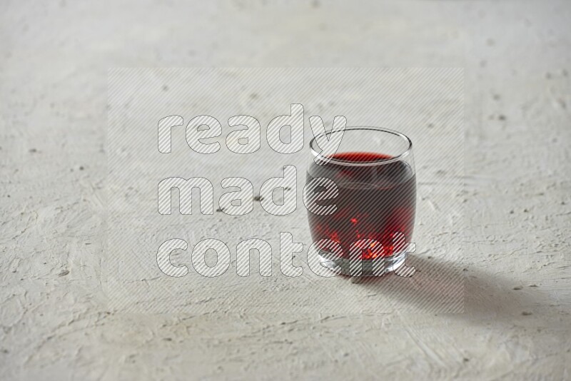 Cold drinks in a glass cup such as water, tamarind, qamar eldin, sobia, milk and hibiscus on textured white background