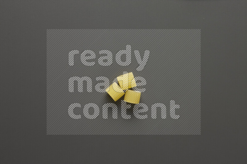 Big rings pasta on grey background