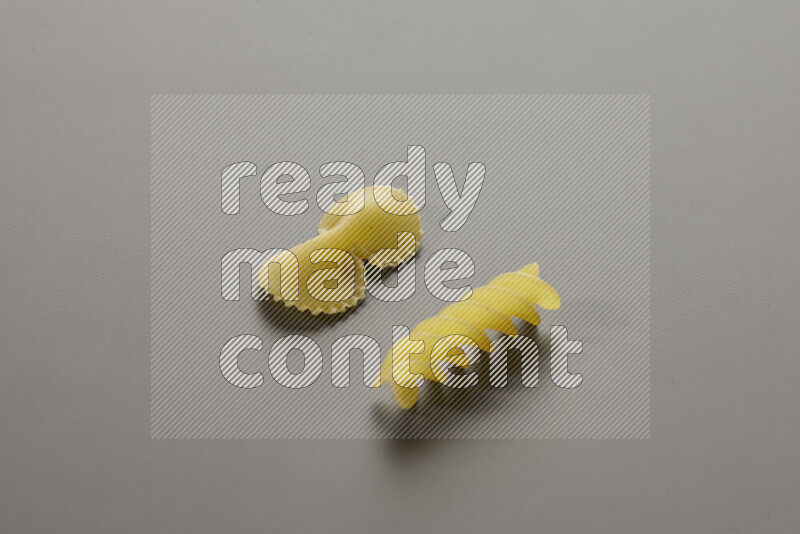 Fiocchi pasta with other types of pasta on grey background