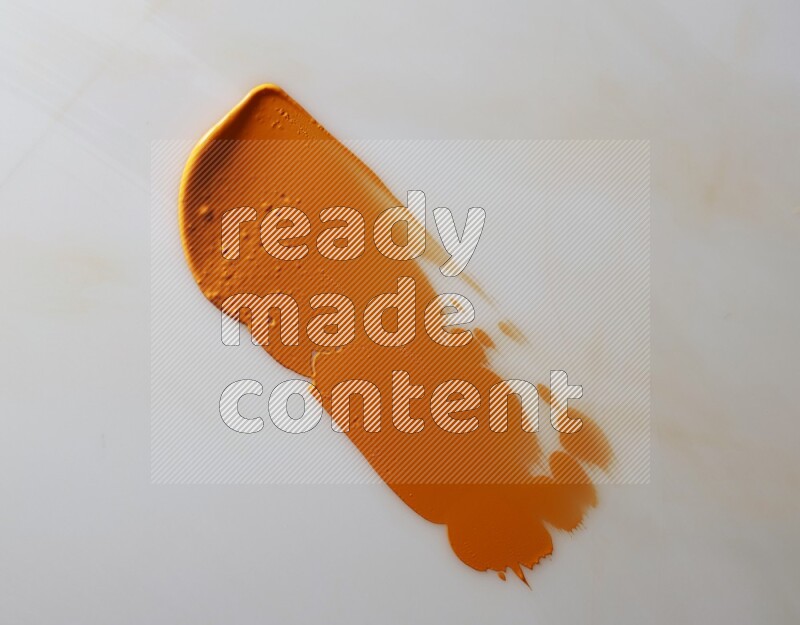 An orange straight painting knife stroke on white background