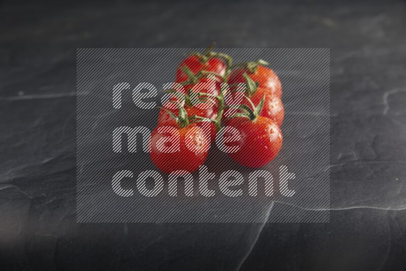 Red cherry tomato vein on a textured black slate background 45 degree