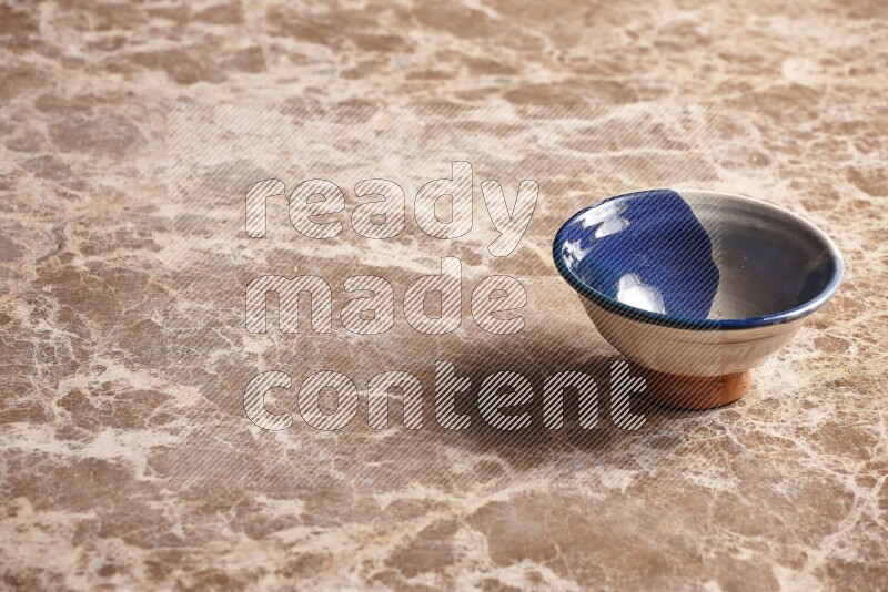 Multicolored Pottery Bowl on Beige Marble Flooring