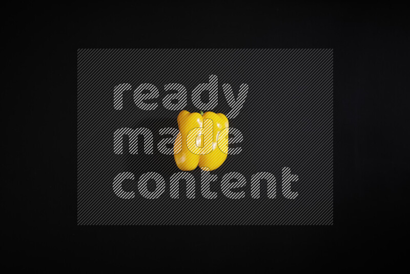 Yellow bell pepper on black background