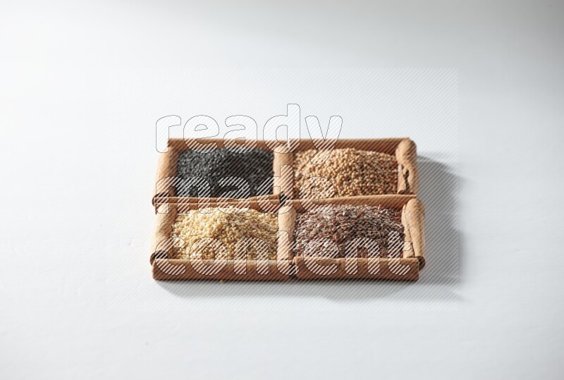 4 squares of cinnamon sticks full of black seeds, mustard seeds, flaxseeds and sesame on white flooring